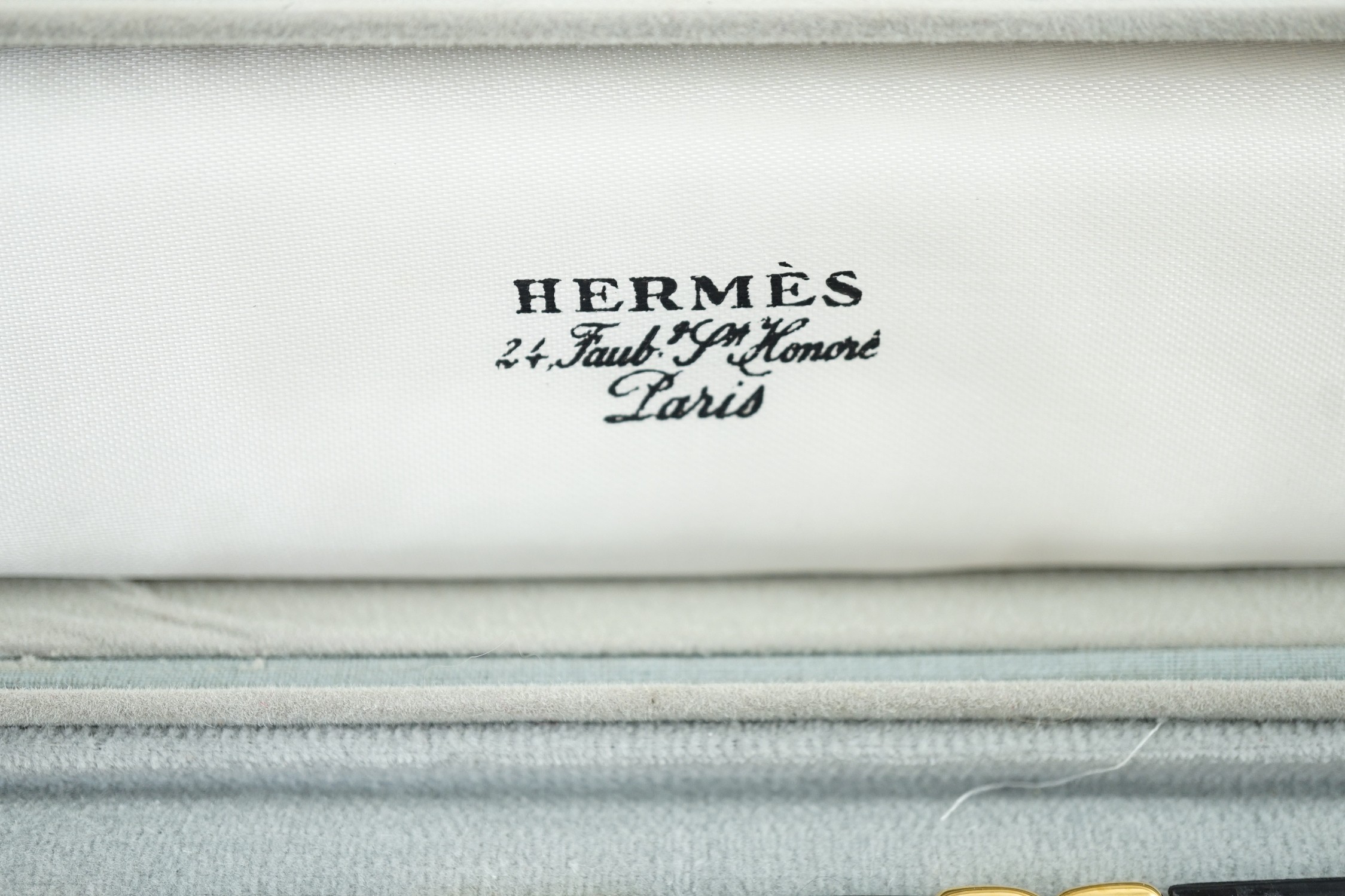 A boxed Hermes navy blue leather and gilt metal bracelet, 19cm.